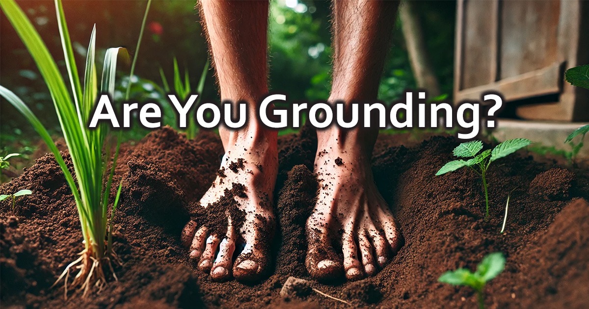 Grounding; Connecting to the earth techniques to improve well-being. Image of two bare feet standing in rich soil.